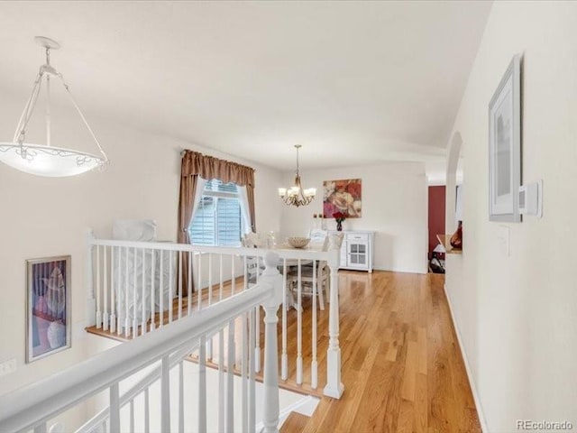 3914 E 116th Pl, Thornton, CO 80233 - corridor with a chandelier, light wood-type flooring, and an upstairs landing