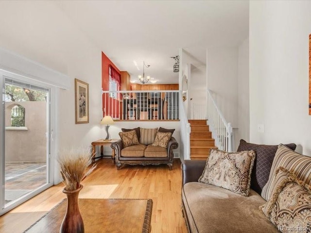 3914 E 116th Pl, Thornton, CO 80233 - living area featuring a chandelier, light wood-style flooring, and stairs