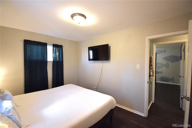 bedroom with dark hardwood / wood-style flooring