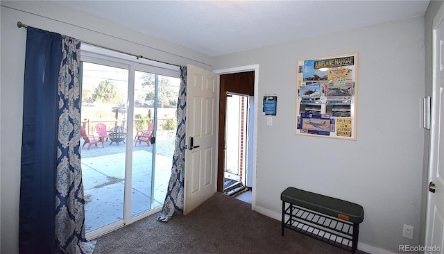 entryway with dark carpet