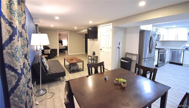 dining space with light hardwood / wood-style flooring