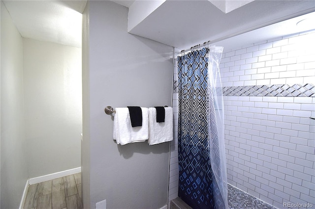 bathroom with hardwood / wood-style floors and walk in shower