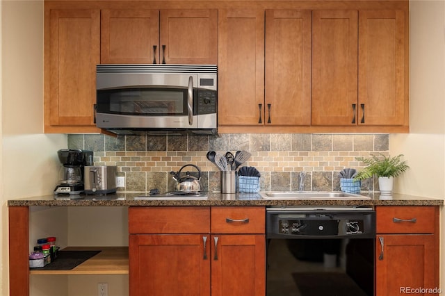580 Winter Park Dr # 4571-4573, Winter Park, CO 80482 - kitchen featuring dark stone counters, a sink, stainless steel appliances, brown cabinets, and backsplash