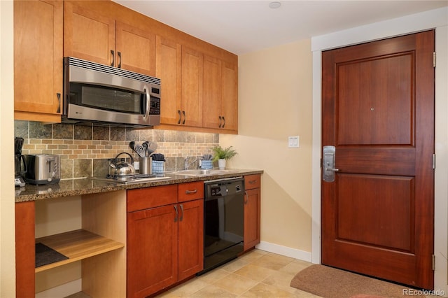 580 Winter Park Dr # 4571-4573, Winter Park, CO 80482 - kitchen featuring black dishwasher, stainless steel microwave, a sink, decorative backsplash, and baseboards