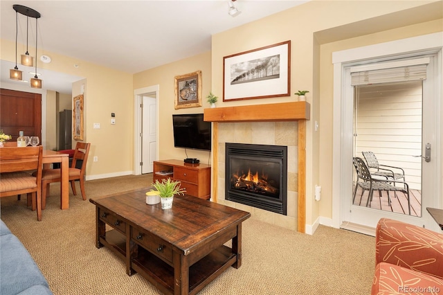 580 Winter Park Dr # 4571-4573, Winter Park, CO 80482 - living room featuring light carpet, a tiled fireplace, and baseboards