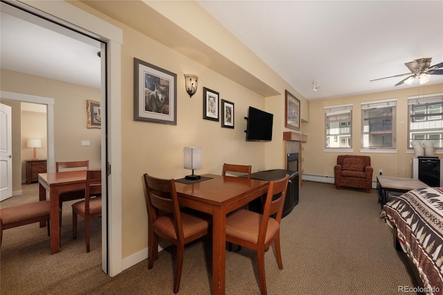 580 Winter Park Dr # 4571-4573, Winter Park, CO 80482 - carpeted dining space with baseboards, a tile fireplace, a baseboard radiator, and a ceiling fan