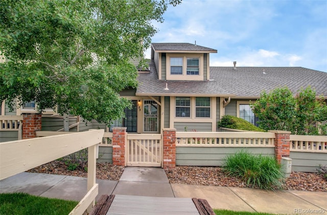 725 Crown Point Dr, Colorado Springs, CO 80906 - view of front of property featuring a fenced front yard, a shingled roof, and a gate