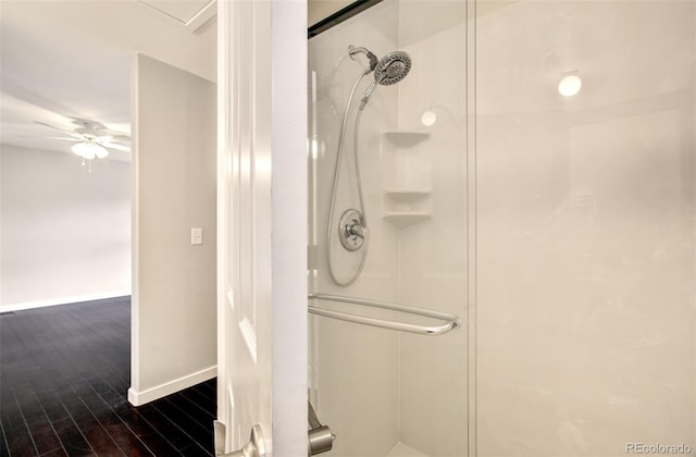 725 Crown Point Dr, Colorado Springs, CO 80906 - bathroom with a stall shower, wood finished floors, baseboards, and a ceiling fan