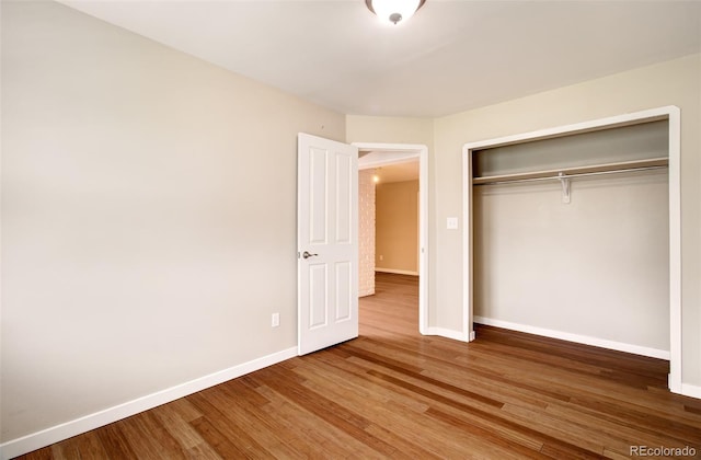 725 Crown Point Dr, Colorado Springs, CO 80906 - unfurnished bedroom featuring wood finished floors, baseboards, and a closet