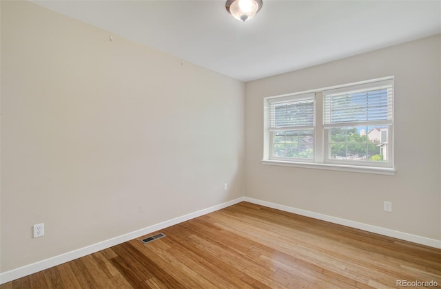 725 Crown Point Dr, Colorado Springs, CO 80906 - spare room featuring baseboards and wood finished floors