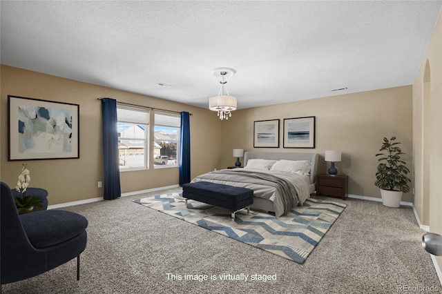 carpeted bedroom with a textured ceiling