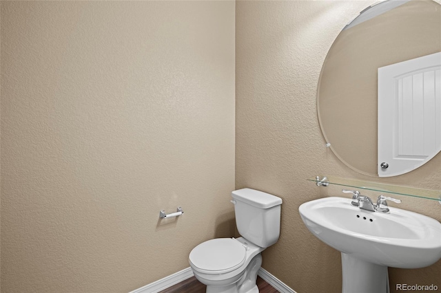 bathroom featuring sink and toilet