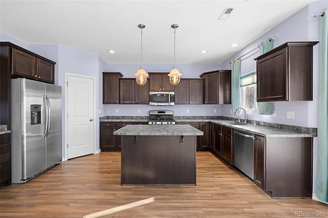 kitchen featuring sink, dark brown cabinets, hanging light fixtures, and appliances with stainless steel finishes