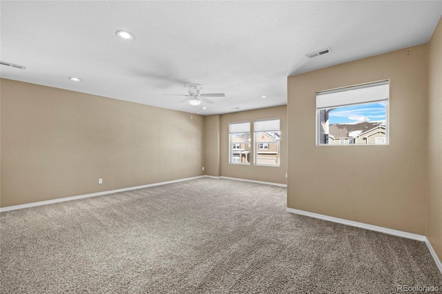 carpeted spare room with ceiling fan