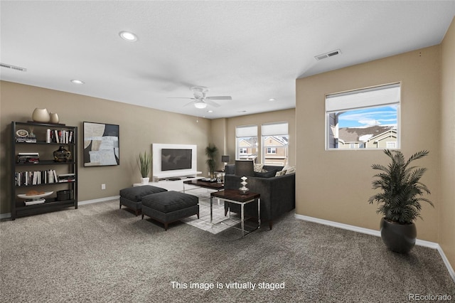 living room with plenty of natural light, carpet flooring, and ceiling fan