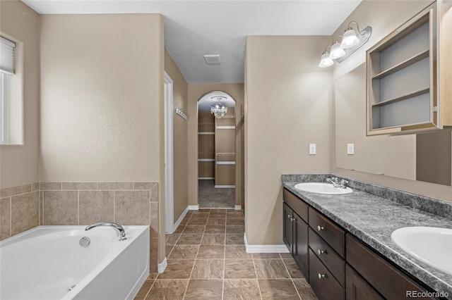 bathroom with a bath and vanity