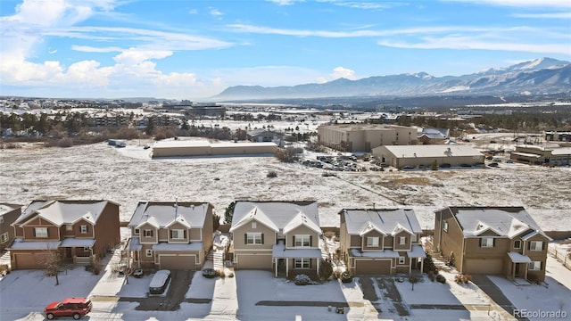 snowy aerial view featuring a mountain view