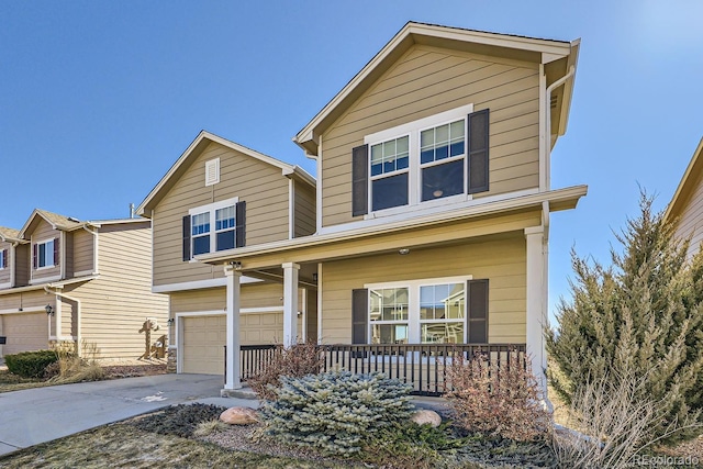 traditional-style home featuring an attached garage, a porch, and concrete driveway