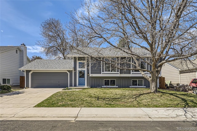 145 S Buchanan Ave, Louisville, CO 80027 - view of front facade with an attached garage, board and batten siding, a front lawn, concrete driveway, and roof with shingles