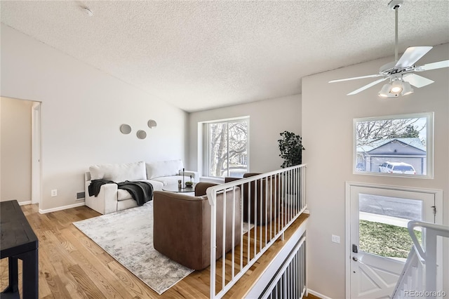 145 S Buchanan Ave, Louisville, CO 80027 - living area featuring a textured ceiling, wood finished floors, ceiling fan, and baseboards