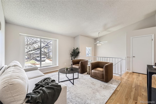 145 S Buchanan Ave, Louisville, CO 80027 - living area featuring wood finished floors, lofted ceiling, a textured ceiling, and ceiling fan