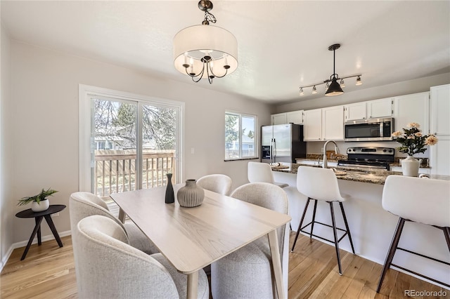 145 S Buchanan Ave, Louisville, CO 80027 - dining area featuring light wood-style floors and a chandelier