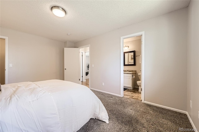 145 S Buchanan Ave, Louisville, CO 80027 - bedroom with carpet flooring, baseboards, ensuite bath, and a textured ceiling