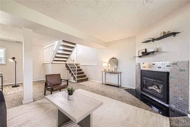 145 S Buchanan Ave, Louisville, CO 80027 - living area featuring a textured ceiling, carpet floors, stairway, baseboards, and a tile fireplace