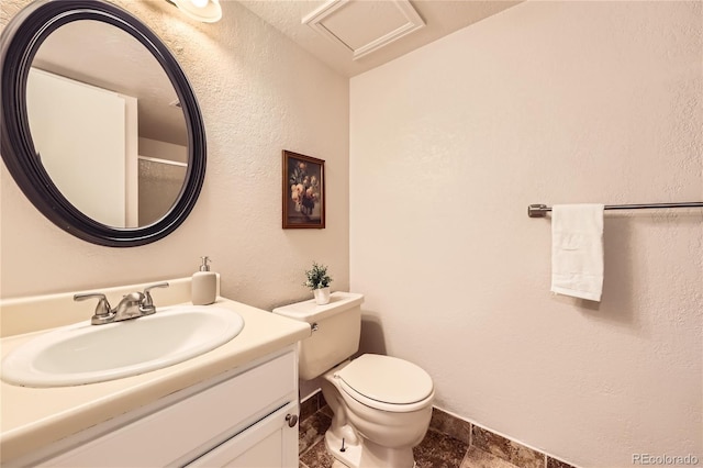 145 S Buchanan Ave, Louisville, CO 80027 - bathroom with toilet, vanity, stone tile flooring, and a textured wall
