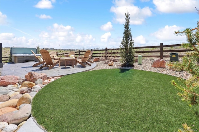 view of yard featuring an outdoor fire pit, fence, and a patio