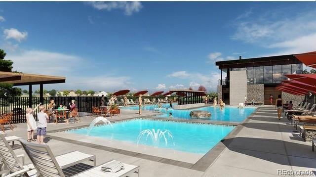 community pool with a patio area and fence