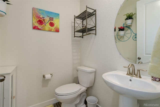 bathroom featuring sink and toilet