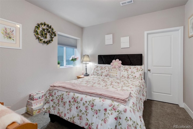 bedroom featuring dark colored carpet