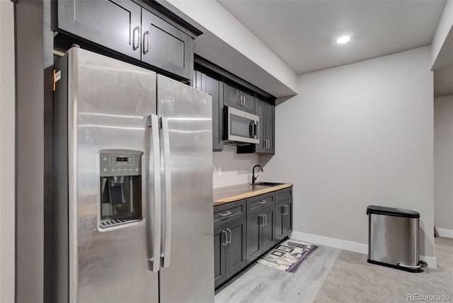 kitchen featuring sink, light hardwood / wood-style floors, and stainless steel appliances