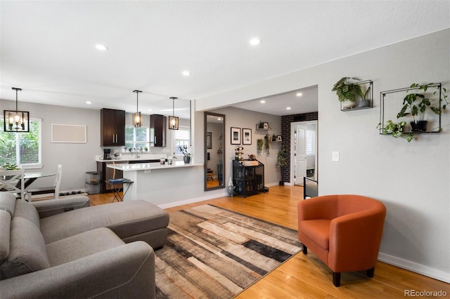 5125 Umatilla St, Denver, CO 80221 - living room featuring light wood-style flooring, recessed lighting, baseboards, and a chandelier