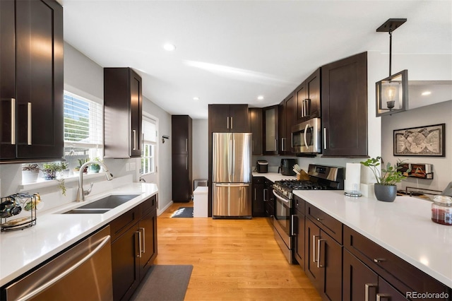 5125 Umatilla St, Denver, CO 80221 - kitchen featuring stainless steel appliances, a sink, light wood-style flooring, light countertops, and recessed lighting