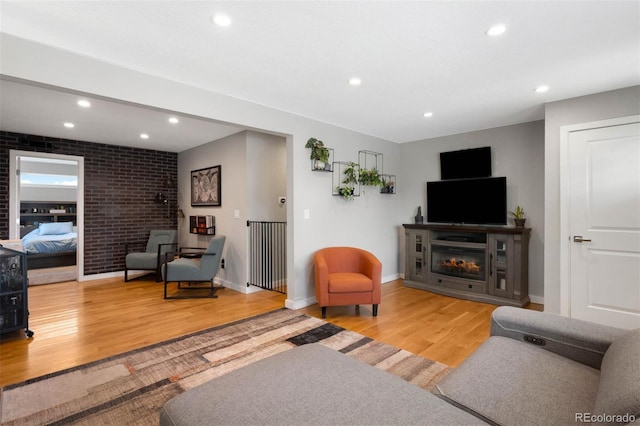 5125 Umatilla St, Denver, CO 80221 - living room featuring a glass covered fireplace, wood finished floors, recessed lighting, and baseboards