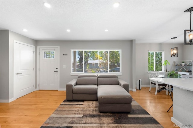 5125 Umatilla St, Denver, CO 80221 - living area featuring light wood-style floors, recessed lighting, and baseboards