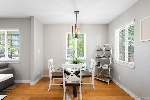 5125 Umatilla St, Denver, CO 80221 - dining area featuring light wood-style floors, plenty of natural light, baseboards, and a chandelier