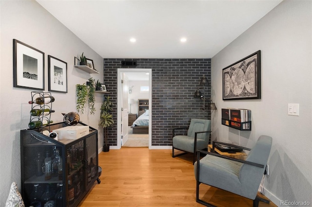 5125 Umatilla St, Denver, CO 80221 - sitting room featuring light wood-style floors, recessed lighting, and brick wall
