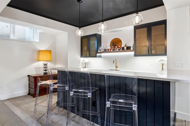 bar featuring sink and pendant lighting