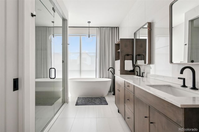 bathroom featuring vanity, separate shower and tub, and tile patterned flooring