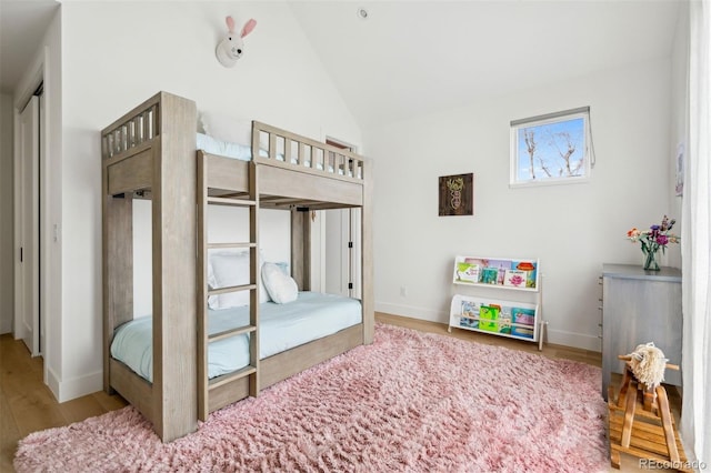 bedroom featuring light hardwood / wood-style flooring and vaulted ceiling