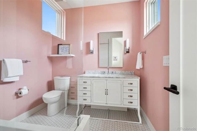 bathroom with vanity, toilet, and tile patterned flooring