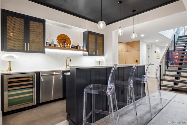 bar with stainless steel dishwasher, beverage cooler, decorative light fixtures, and sink