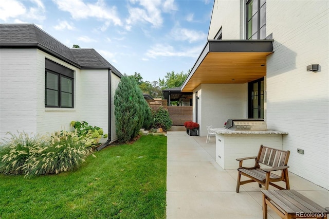 view of yard featuring area for grilling and a patio area