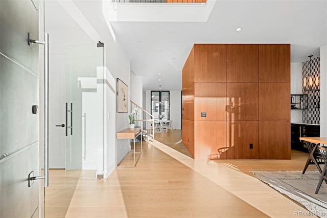 corridor featuring light wood-style floors, recessed lighting, and stairway