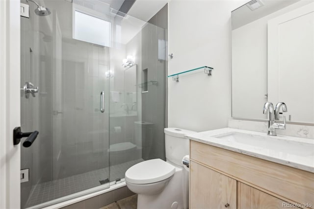 full bathroom featuring a stall shower, visible vents, vanity, and toilet