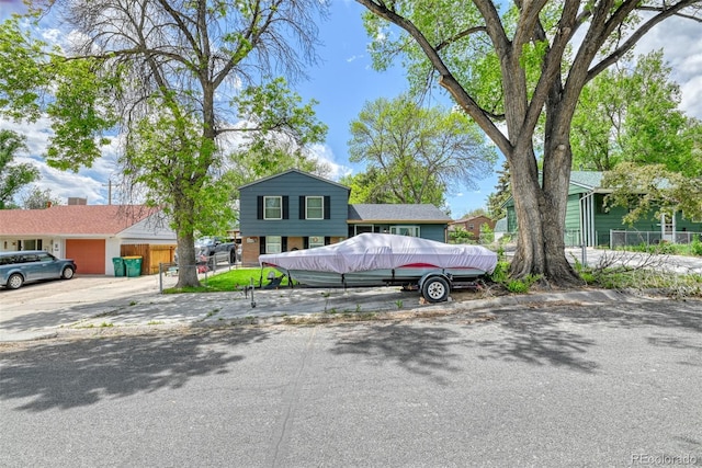 12 Arrawanna St, Colorado Springs, CO 80909 - tri-level home with a garage and concrete driveway