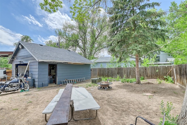 12 Arrawanna St, Colorado Springs, CO 80909 - fenced backyard with an outdoor fire pit and an outdoor structure
